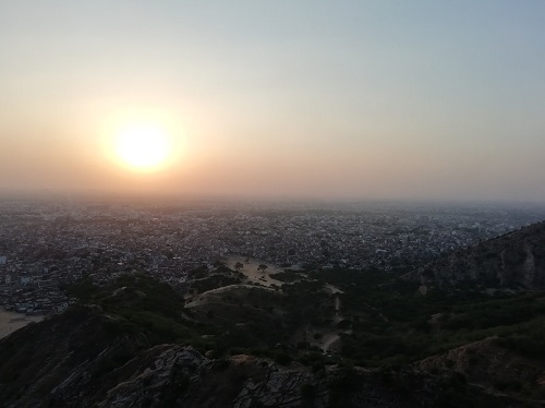 高地からインドの街に夕日が沈む様子を撮影した1枚
