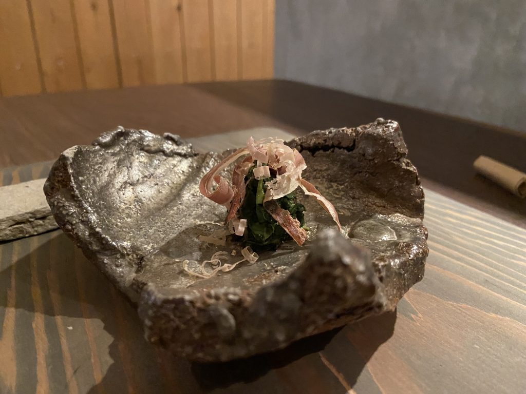 目の前で削られた鰹節がかけられた玉露の茶葉。岩のようなお浚い茶葉が盛り付けられています。